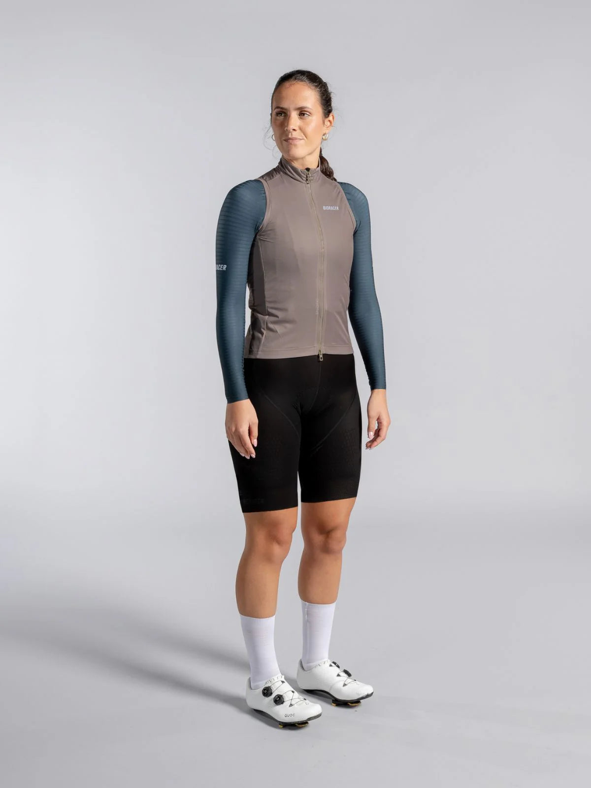 Person wearing a cycling outfit with a gray background