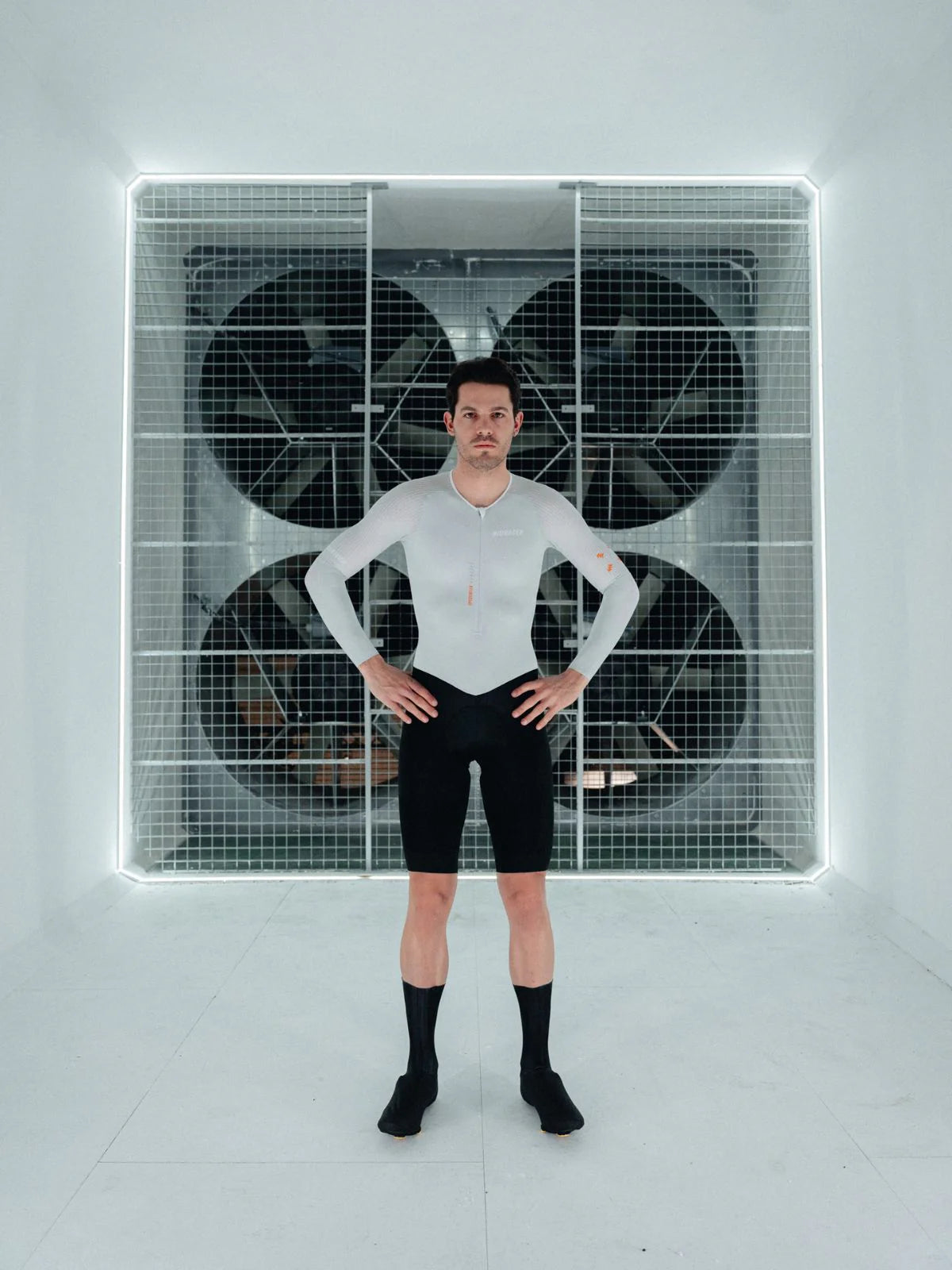 Person standing in front of a large air conditioning unit with a grid pattern.