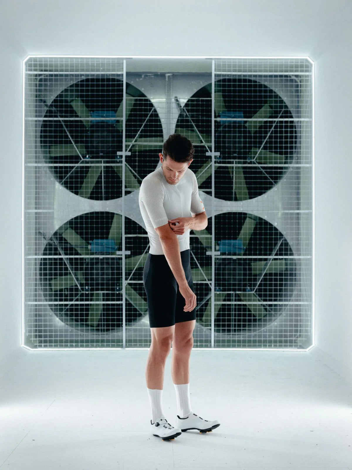 Person standing in front of a futuristic wall with circular panels