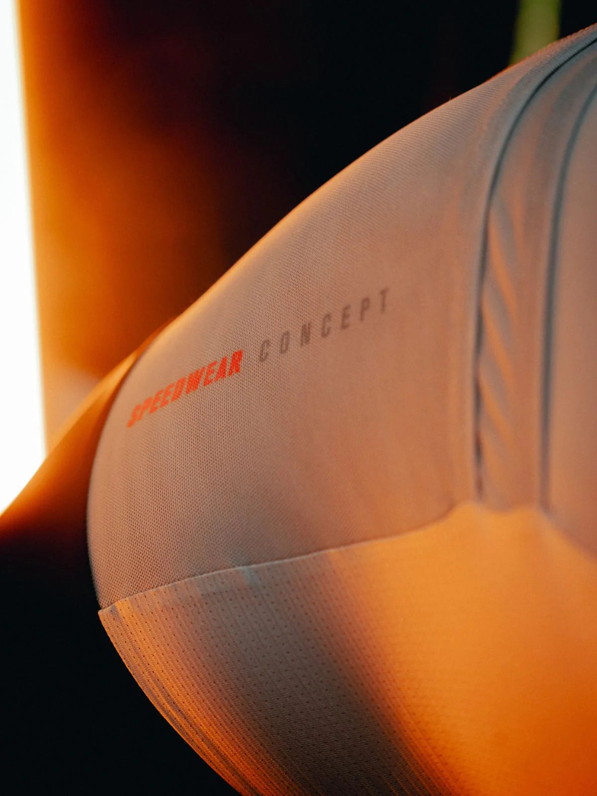 Close-up of a sports outfit with 'Speedwear Concept' branding on a blurred background
