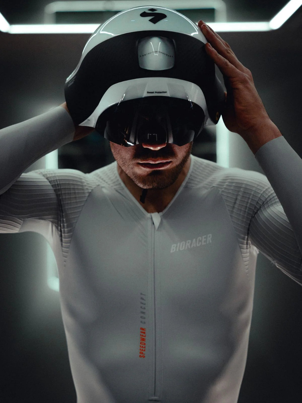 Person wearing a white racing suit and helmet with 'Biogacer' branding.