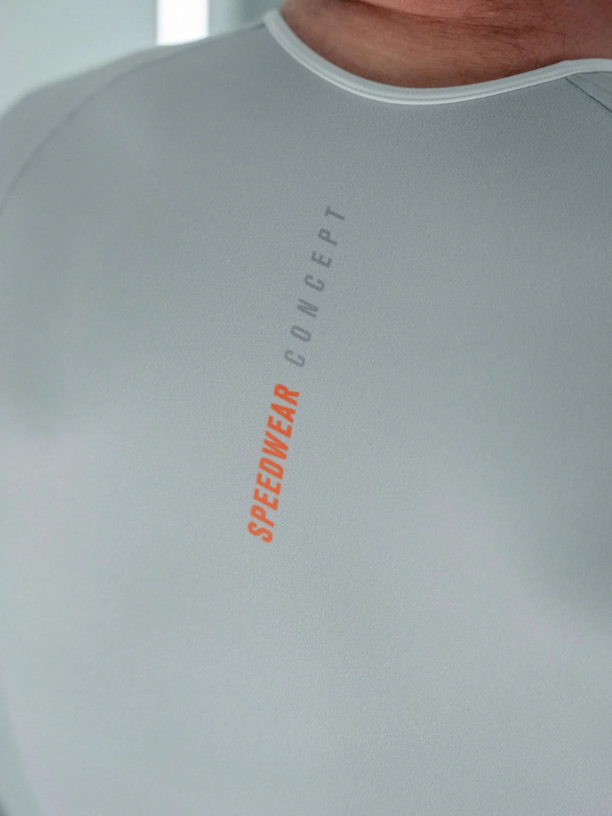 Gray athletic shirt with 'Speedwear Concept' text on a plain background